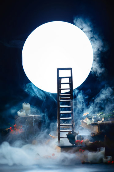 Ladder to the Moon. Conceptual still life wih smoke, night scene with candles and books. Dark still life with copy space.