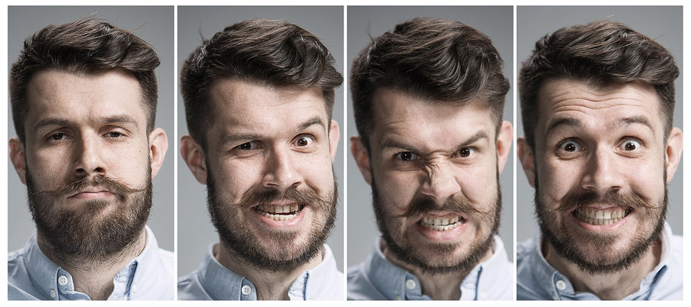 Set of young man's portraits with angry emotions on gray background