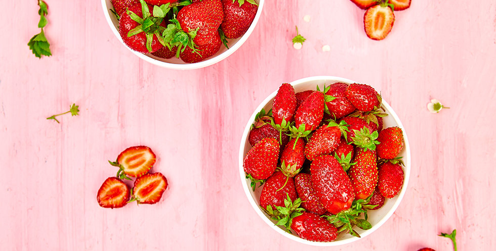 Ripe red strawberries on pink table, Strawberries in white bowls. Fresh strawberries. Beautiful strawberries. Diet food. Healthy, vegan. Top view. Flat lay.
